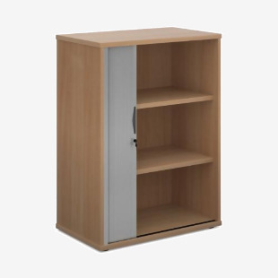 The photo shows a tall, 1090mm single door tambour cupboard in a beech color with a silver door. It includes 2 shelves and has a universal design, perfect for any office space. The tambour doors are closed, providing a sleek and modern look.