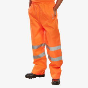 The photo captures a pair of bright orange Beeswift High Visibility Trousers, specifically designed for traffic wear. These size 2XL trousers, known as TENORXXL, are made for durable and comfortable performance.