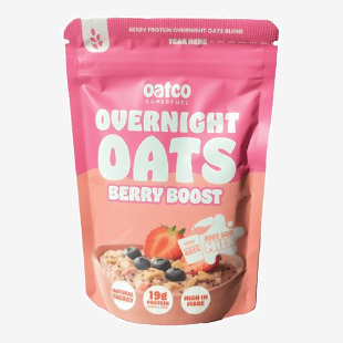 Photo shows a box of Oatco Overnight Oats Berry Boost with twelve 70g sachets. Packaging features the Oatco logo, purple and white color accents, vivid berry and oat imagery, clear product name text and small icons, neatly arranged on a neutral background.