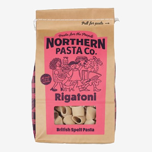 A grocery-shelf photo shows bright yellow Northern Pasta Co. rigatoni packages arranged in a neat row. Clear windows reveal short, ridged tubular pasta. Brand logo and simple graphics sit above nutrition text, while light reflects off the glossy packaging.