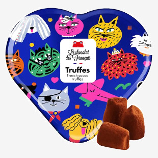 A small decorative tin features retro-style dog and cat illustrations and the Le Chocolat des Français logo. Opening it reveals a neat array of dark chocolate truffles with glossy surfaces that nestle against a contrasting interior lining.