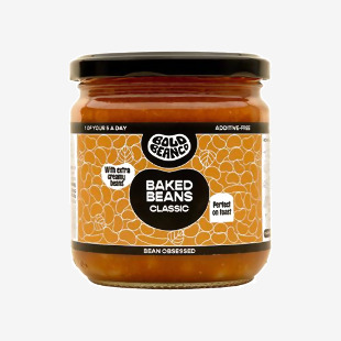 A round tin displays the Bold Bean Classic Baked Beans label with bold navy and orange colors. The 325g weight appears near the brand name. A glossy photograph of baked beans fills a circular window while ingredient and nutritional text line the bottom and sides. Glossy lid and slightly crimped rim.