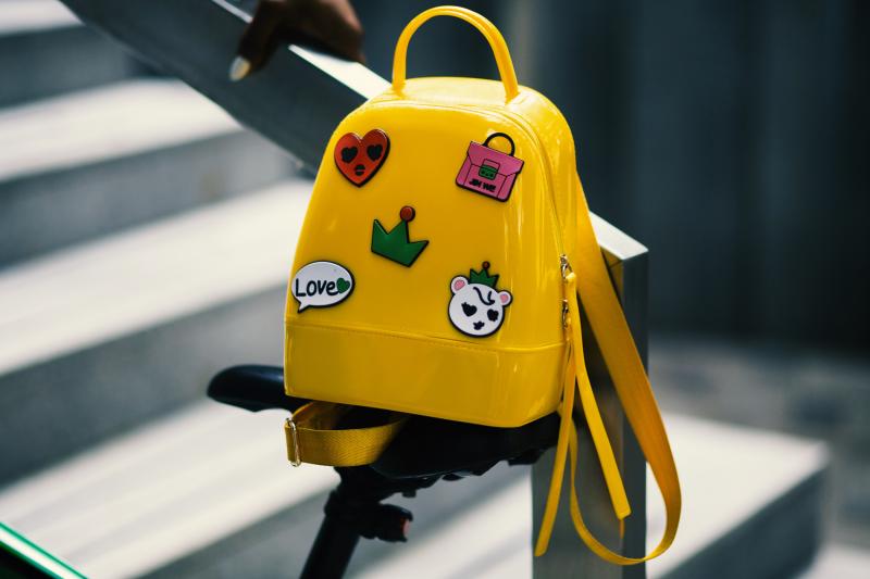 yellow backpack with stickers on