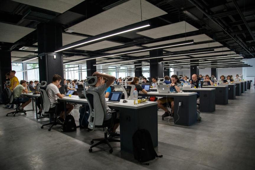 Busy workplace with people working at their desks 