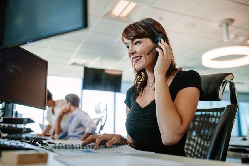 Customer service team sat at a desk 