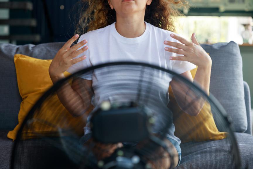 Woman sat in front of a fan 
