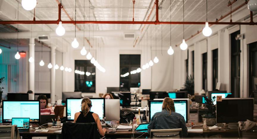 Picture of an office space with people sat in chairs 