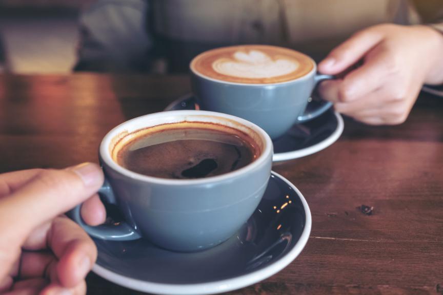 Two coffee cups on desk 